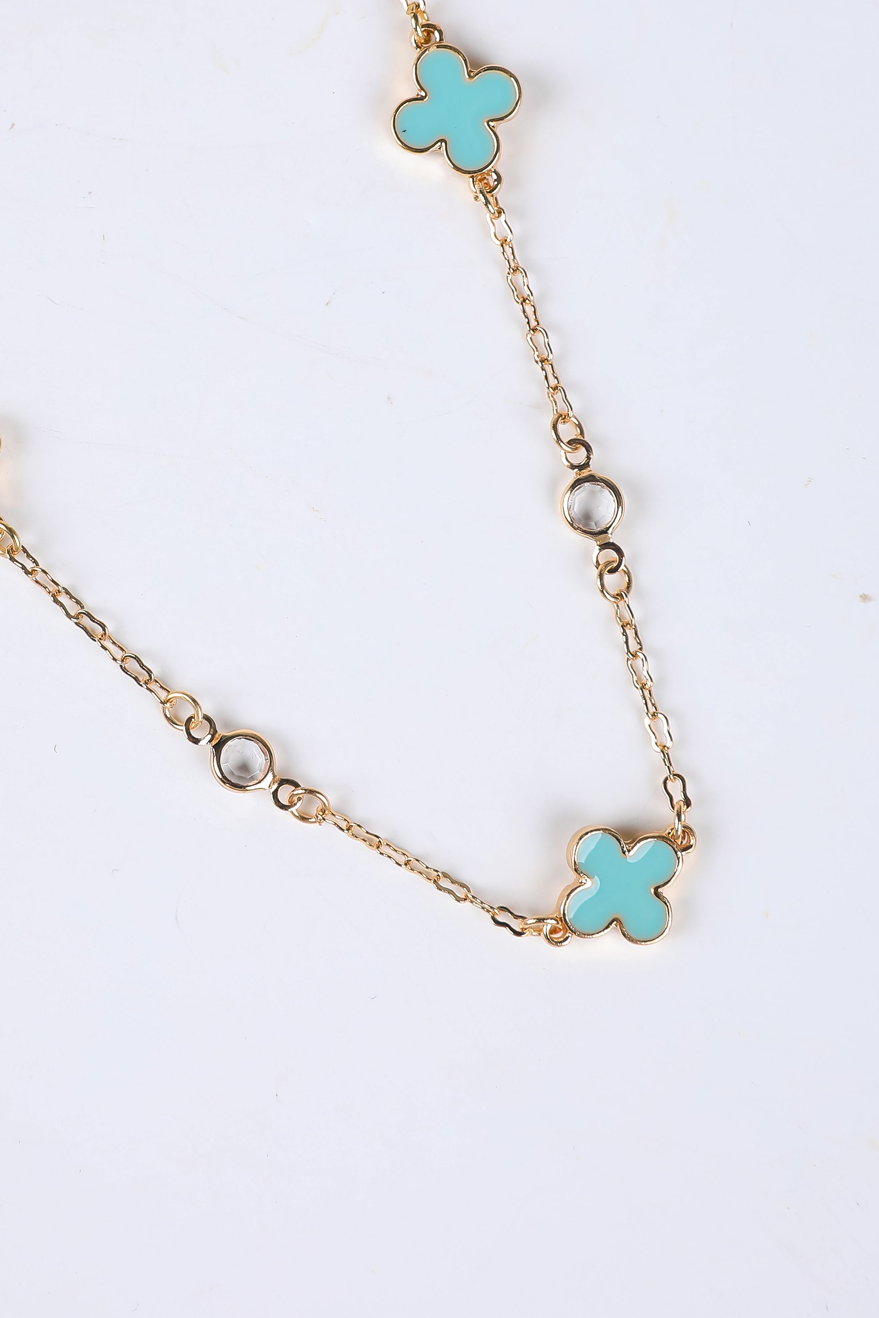 Necklace with turquoise flower pendants on a white background